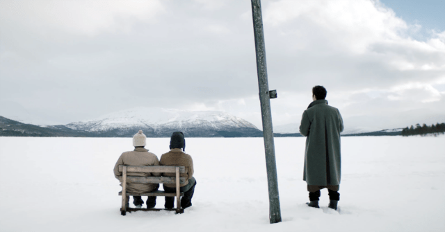 A Happy Day film still of figures seated at a bus stop