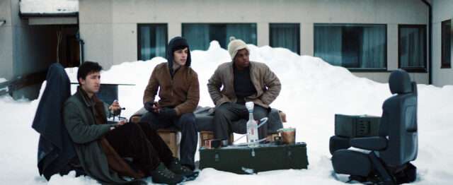 A Happy Day film still of friends sitting in the snow