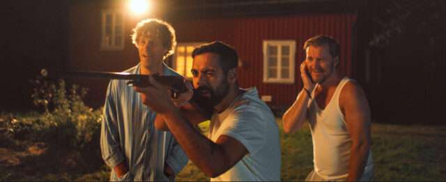 Film still from Hunters on a White Field depicts a man sighting a rifle