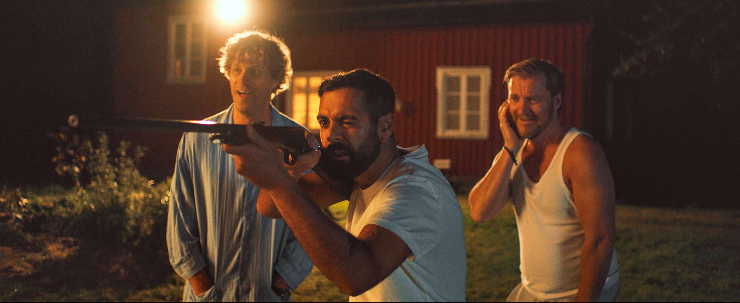 Film still from Hunters on a White Field depicts a man sighting a rifle