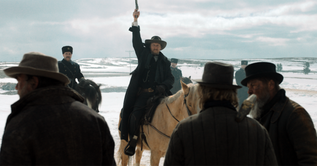 Film still of a man shooting his gun in the air