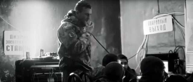 Documentary still of a soldier pausing mid-battle in the war on Ukraine.
