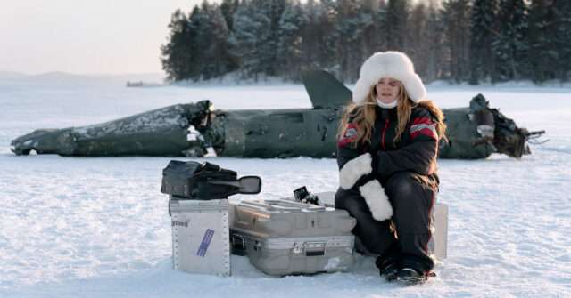 Film still of Oona Airola sitting in front of the downed Russian missile.